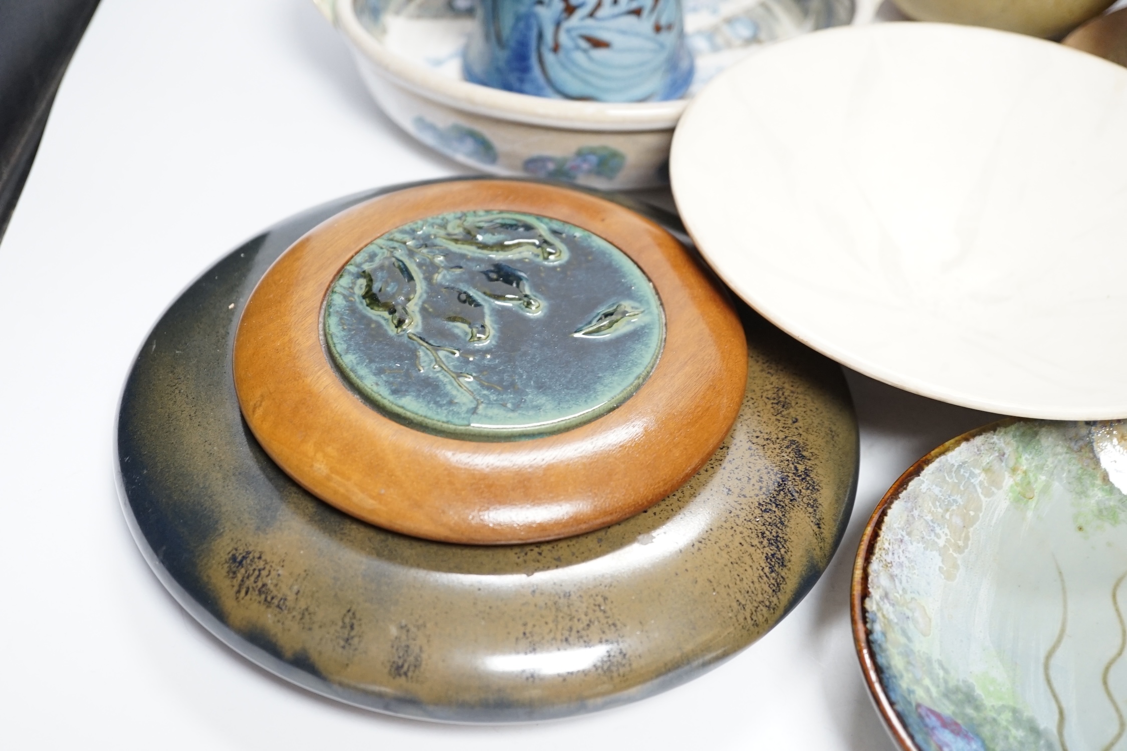 Eight studio pottery items including a cylindrical pot by Mary Rich, a Brenda Wright serving dish, a Tony Gant vase, etc.